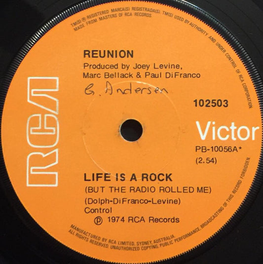 Reunion (3) : Life Is A Rock (But The Radio Rolled Me) (7", Single)
